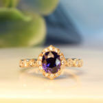 Art deco Proposal Ring with colour change sapphire, surrounded with diamonds to impart a floral and feminine look to this design. This design exudes an overall vintage art deco look with its mil-grain design | Local Singapore Private Jeweller in customised proposal ring.