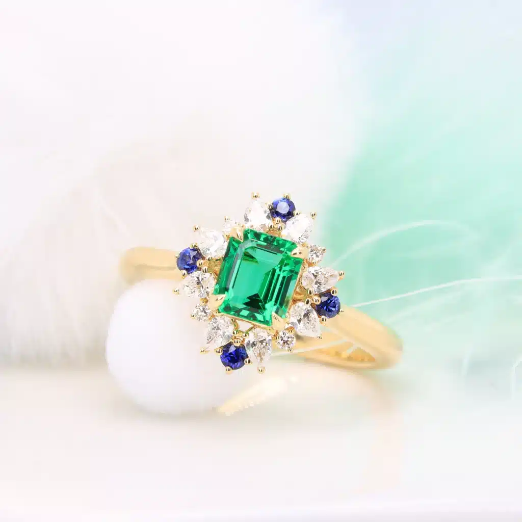 Emerald Proposal Ring with Halo Diamond Ring with diamond and blue sapphire in Singapore by GIOIA Fine Jewellery
